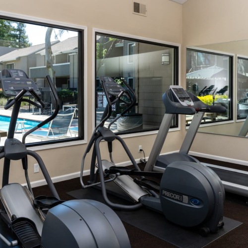 fitness center with large windows and exercise equipment