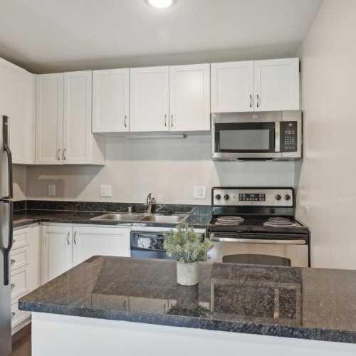 a kitchen with white cabinets